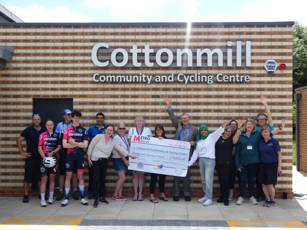 Stakeholders posing with cheque towards the community and cycling centre